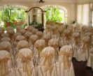 Soft Gold Brocade Chair covers with Gold Organza Bows. A beautiful wedding ceremony.