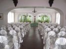 Satin chair covers and organza bows. Silver and white ceremony.